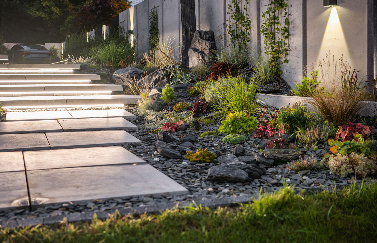 Outdoor lighting installation with wall-mounted fixtures and landscape lights by B-Line Electric LLC